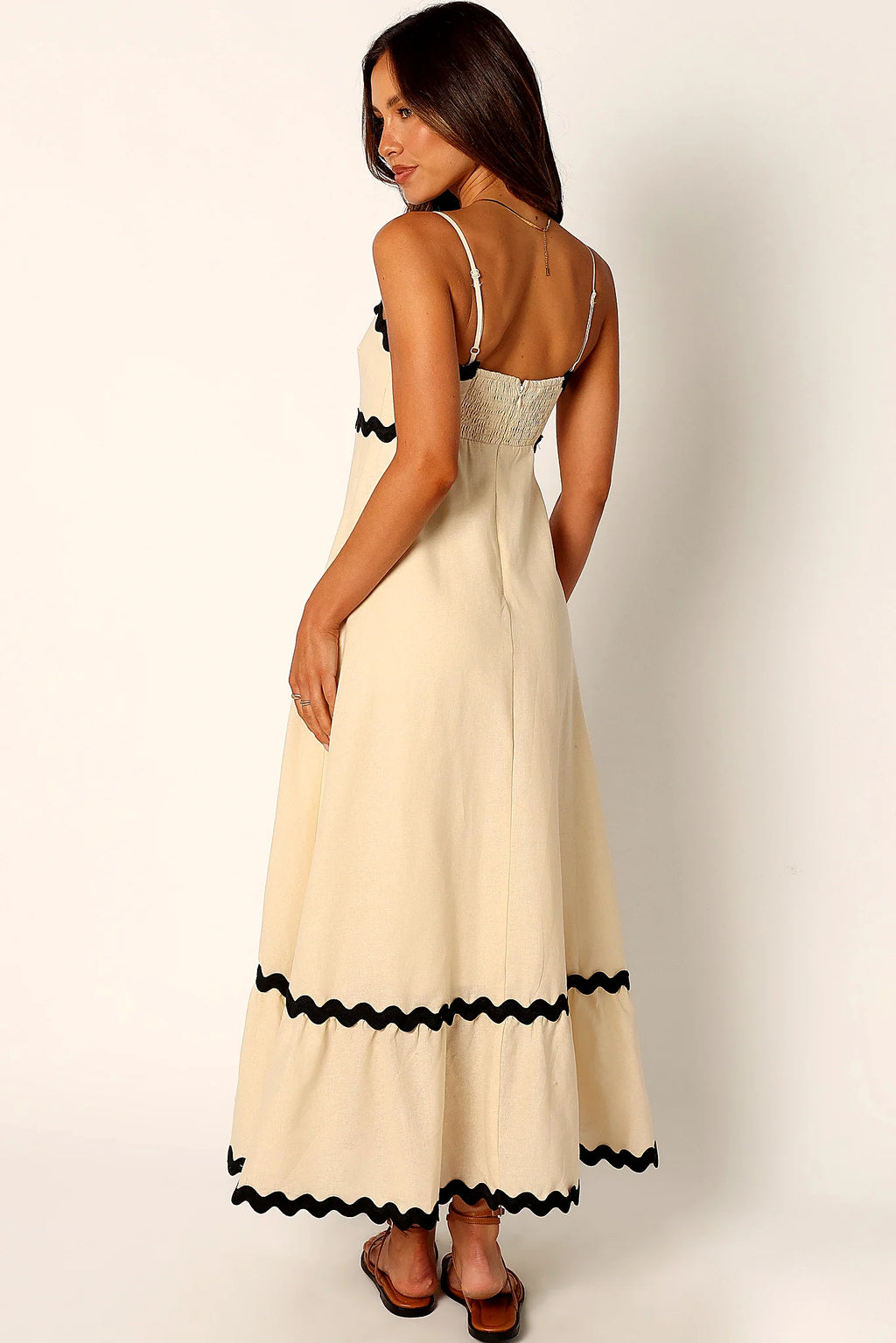 Close-up detail of a black cream & black relaxed maxi dress, showing the fabric and hem finish