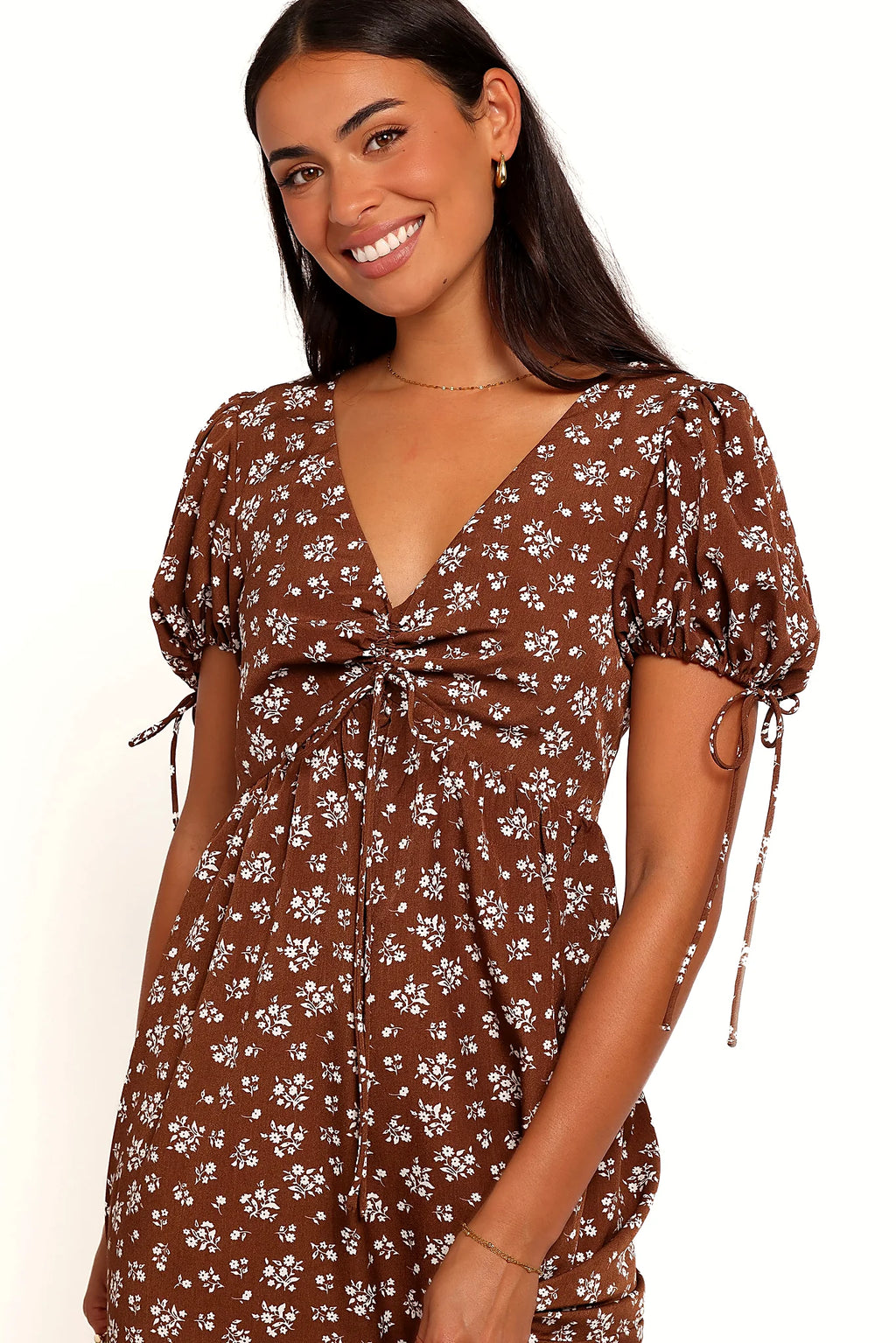 Front view of a brown ditsy floral maxi dress, showing the fabric and hem finish